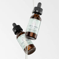 Gua Sha Face Oil – Botanical Elixir, Front arrangement with elixir dripping